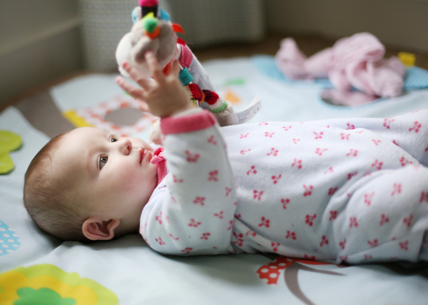 bebé com brinquedo na mão