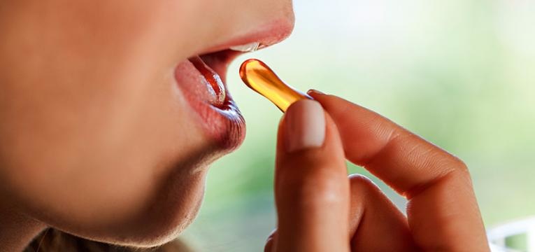 Mulher a tomar vitamina D3